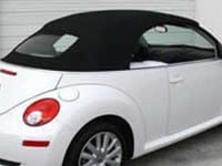 A white convertible beetle with fabric top