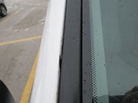 Damage done to the windshield edge on a car from a bad windshield installation